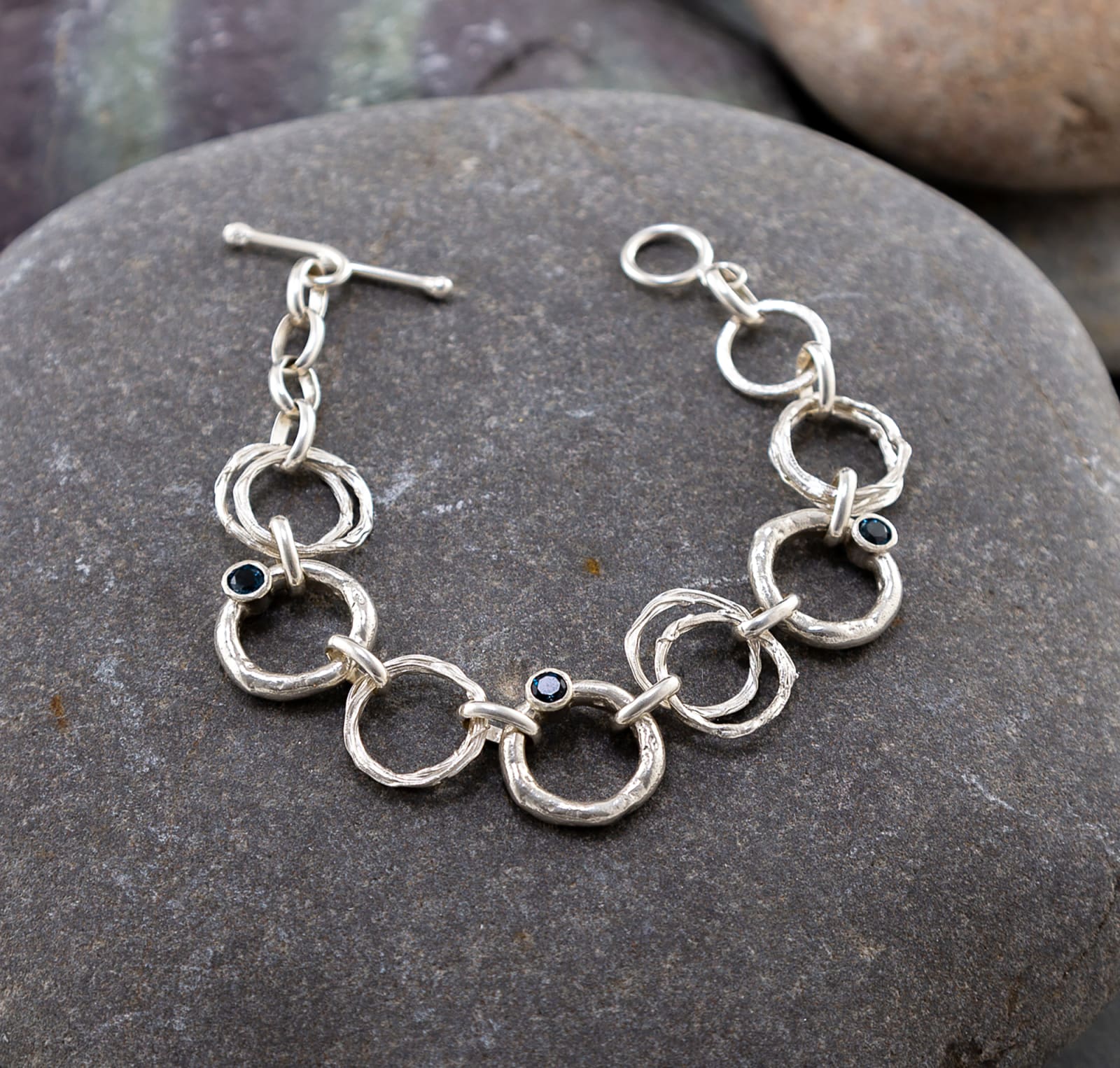 whitewatergallery-marsha-drew-rockpool-chain-link-bracelet-with-hammered-and-molten-silver-links-and-three-london-blue-topaz-stones